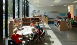 Montessori Elementary students working in a classroom bathed in natural light
