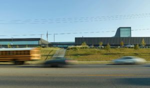 The building's new cohesive exterior face seen from MLK boulevard to the south amidst busy traffic from cars and busses