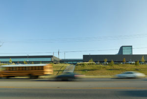 The building's new cohesive exterior face seen from MLK boulevard to the south amidst busy traffic from cars and busses