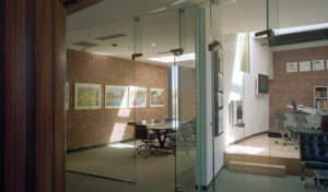 Brick and glass office spaces with cut skylights displaying ample natural lighting from above