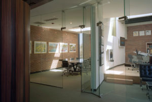 Brick and glass office spaces with cut skylights displaying ample natural lighting from above