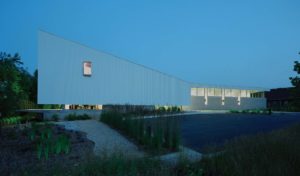 A view of the buildings beautiful white exoskeleton and night with lights shining from inside