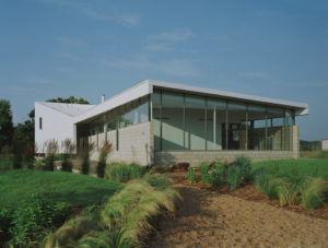 The Srygley Office Building exterior view of concrete block walls and a white metal wall and roof