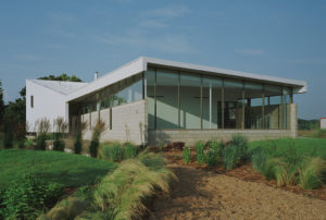 The Srygley Office Building exterior view of concrete block walls and a white metal wall and roof