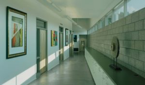 The Srygley Office Building hallway with concrete blocks opposing white walls with hanging artwork