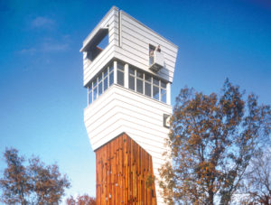 Keenan TowerHouse bright white tower with wooden supports which hoist the house above the treeline