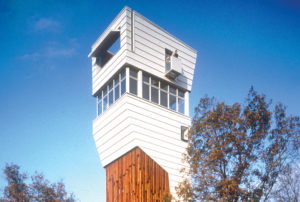 Keenan TowerHouse bright white tower with wooden supports which hoist the house above the treeline