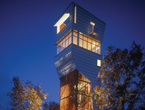 Keenan TowerHouse lit up at night as it towers over trees in the forest