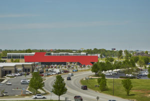 Harvey Pediatric Clinic red building face show in context of the surrounding area of busy roads and green trees