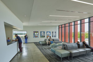 Harvey Pediatric Clinic waiting room with angled cut-out reception area and furniture looking out large glass windows