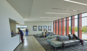 Harvey Pediatric Clinic waiting room with angled cut-out reception area and furniture looking out large glass windows