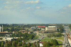 A view of the cayenne color face of the building from an aerial view in downtown rogers