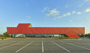 Harvey Pediatric Clinic red metal and glass profile shot looking across parking spots