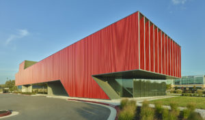 The clinic's corner showing metal cladding leaning forward as if pushing the large windows of the second floor forward in motion