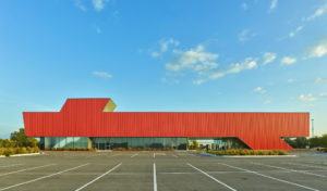 Harvey Pediatric Clinic red metal and glass profile shot looking across parking spots