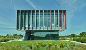 Harvey Pediatric Clinic font-on exterior view of vertical metal features looking through glass to the building interior