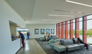 Harvey Pediatric Clinic waiting room with angled cut-out reception area and furniture looking out large glass windows
