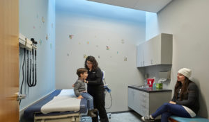 Harvey Pediatric Clinic exam room showing a child and doctor during an exam with natural light coming from the ceiling