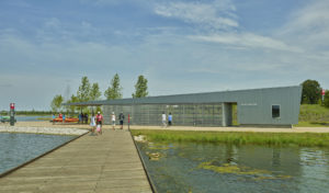 A view from the dock looking back at the Boathouse as people walk by