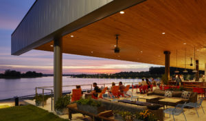 Exterior seating area by the water at night