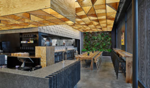 The restaurant space showing a beautiful mix of materials of concrete masonry units and plywood