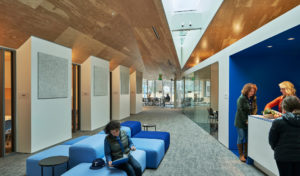 Lounge area with sharp angled ceiling above teachers gathering in the space