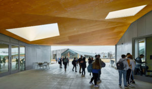 Thaden Reels covered modern-looking entrance with school children lined up to enter