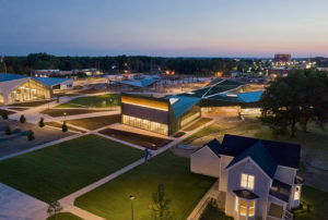 Thaden Reels aerial photo of modern building surrounding grounds at night
