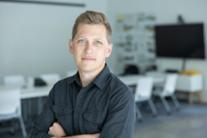 MBA team member headshot featuring an architect wearing a cool-gray button-up shirt